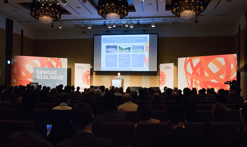 Sendai Dialogue plenary hall with branded stage and screens