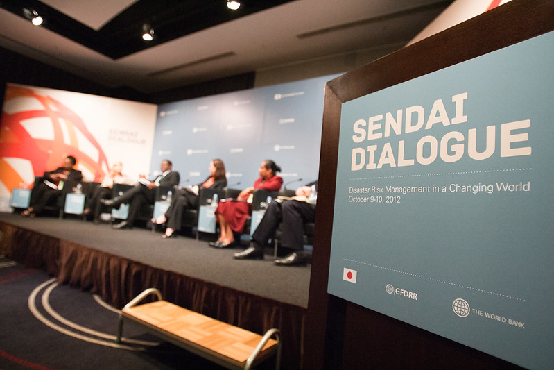 Sendai Dialogue podium sign and panel on stage